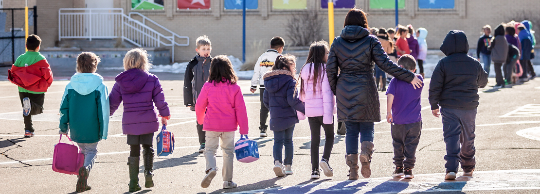 Ashley Elementary students walk with a teacher during recess