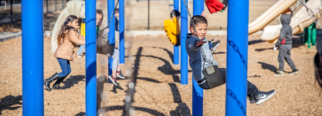 Ashley Elementary student playing on the swings during recess