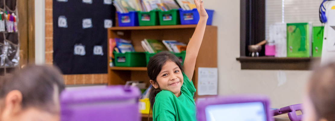 Ashley Elementary student raises her hand in class